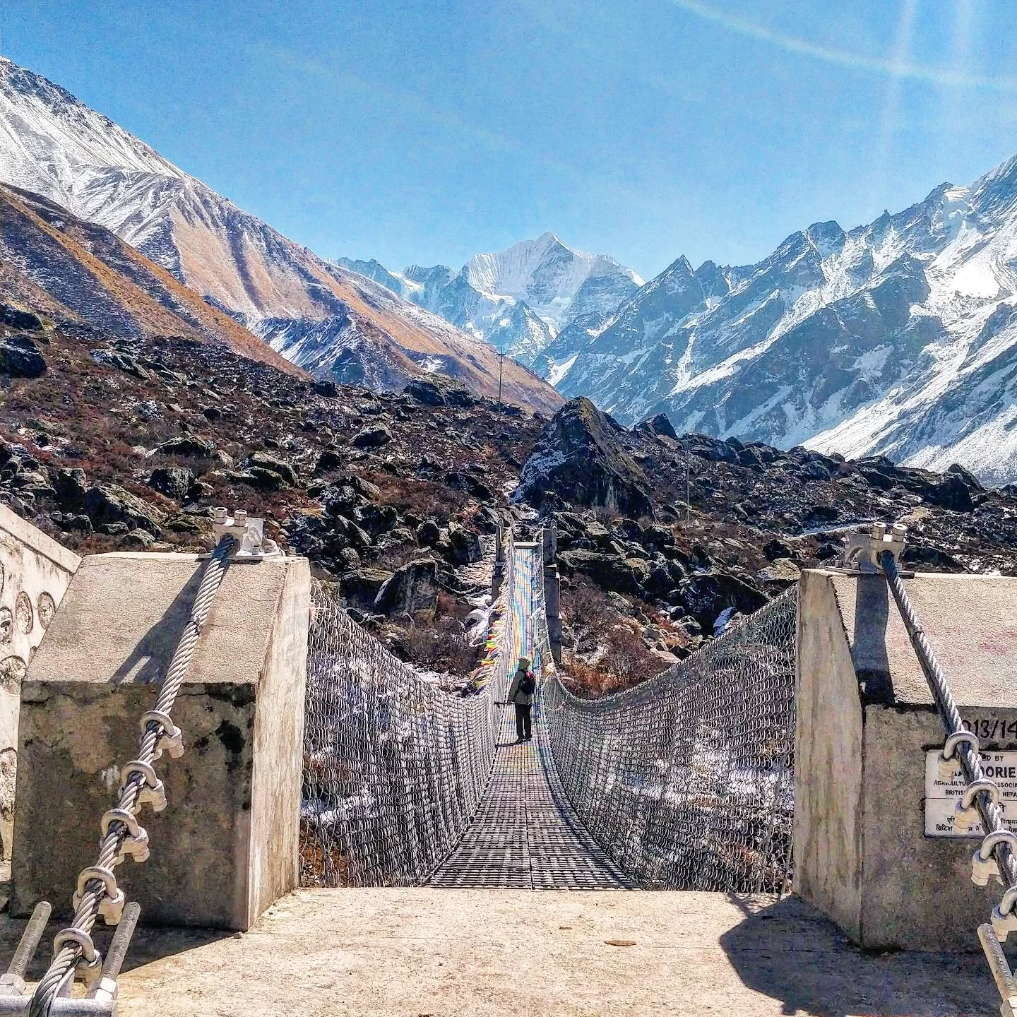 Crossing suspension bridge just before reaching Kyanjin Gumba